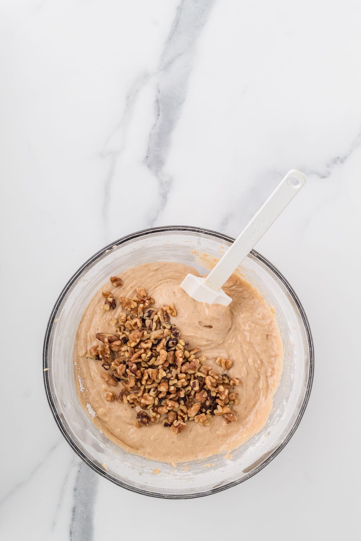 Chopped walnuts added to banana bread muffin batter