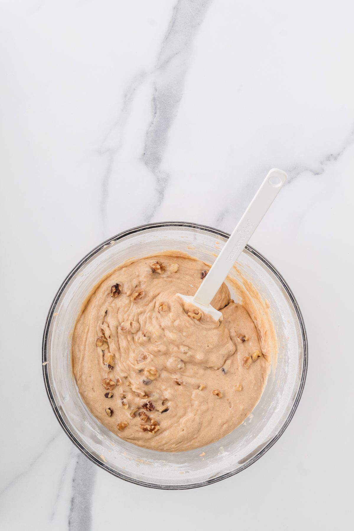 Banana bread muffin batter with walnuts folded in