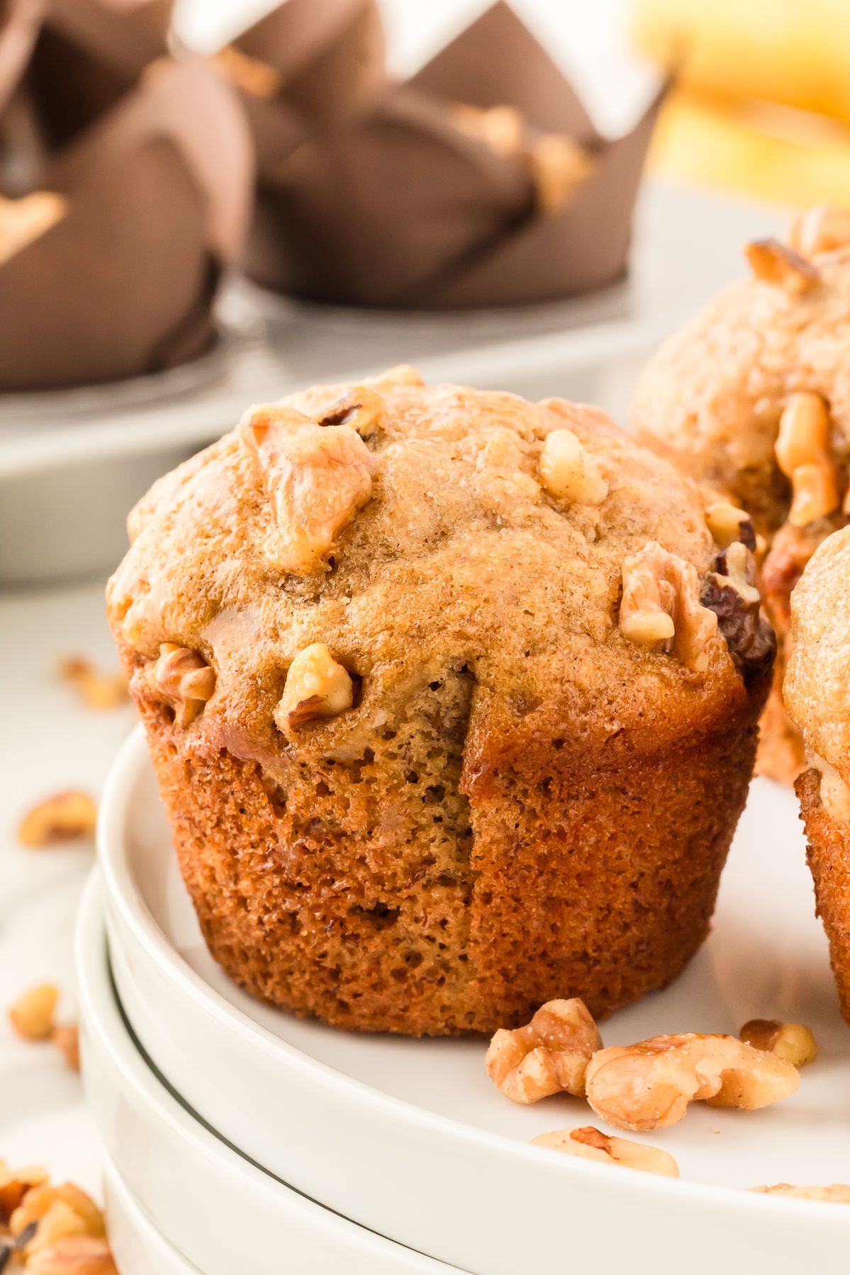 Close up of a walnut topped banana bread muffin