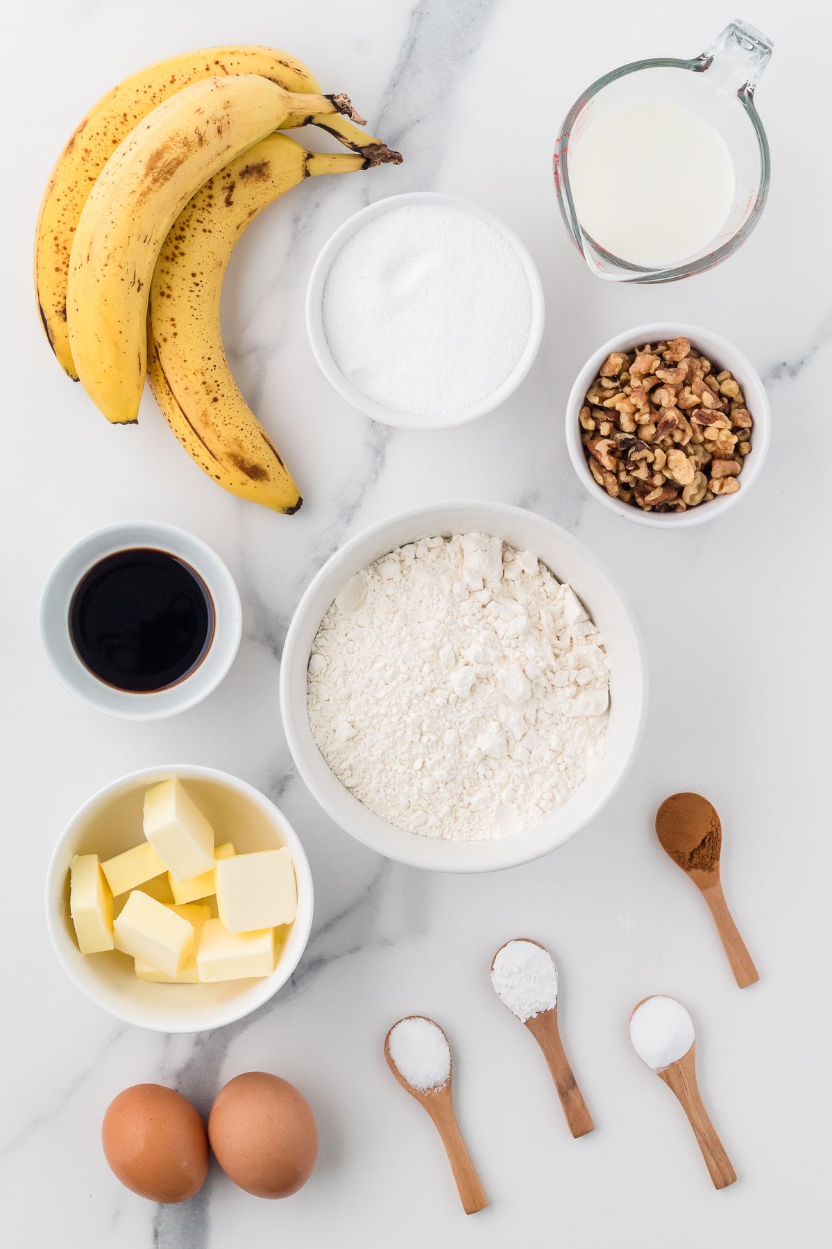 Ingredients for banana bread muffins: ripe bananas, walnuts, flour, butter, sugar, milk and eggs