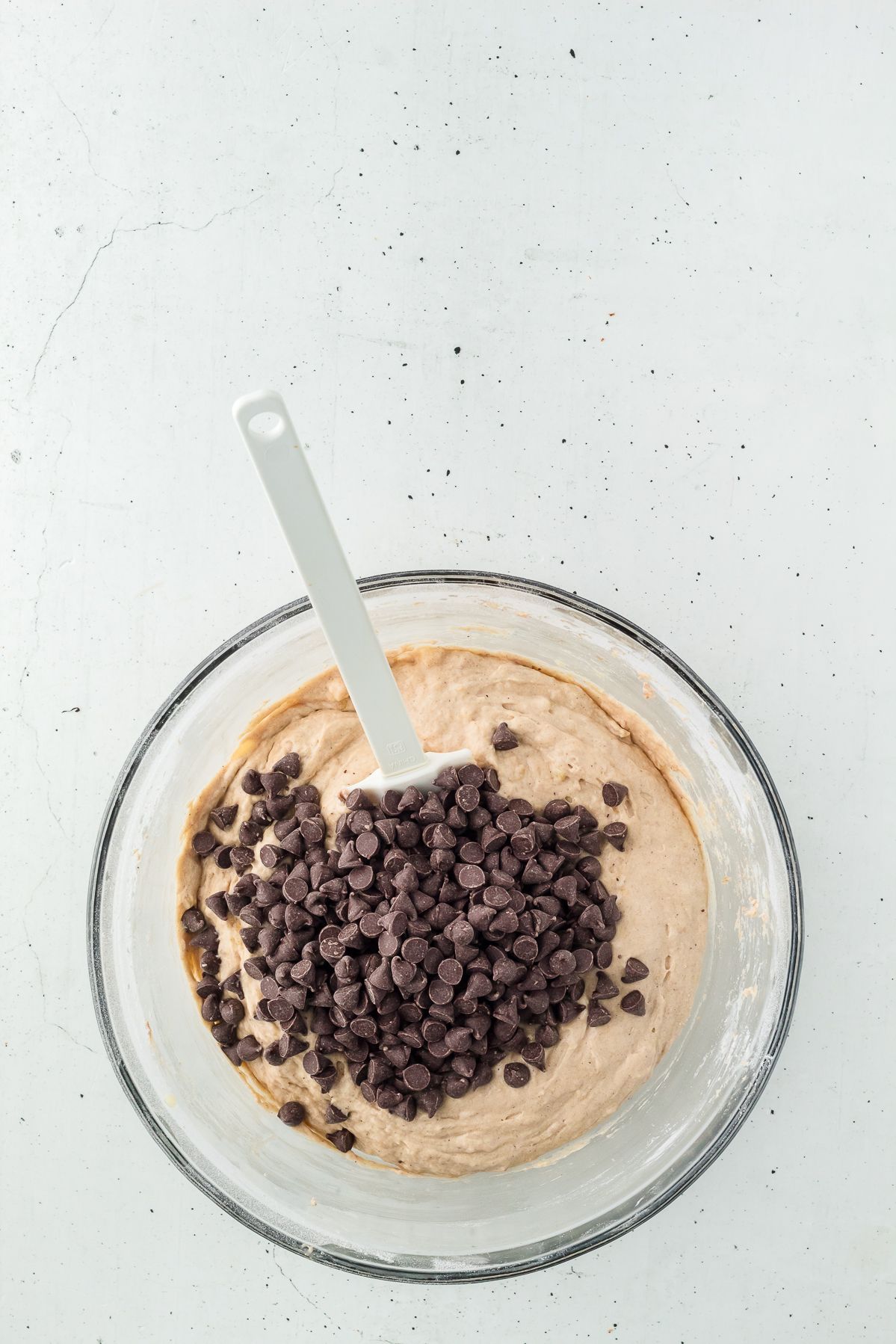 Chocolate chips added to banana muffin batter