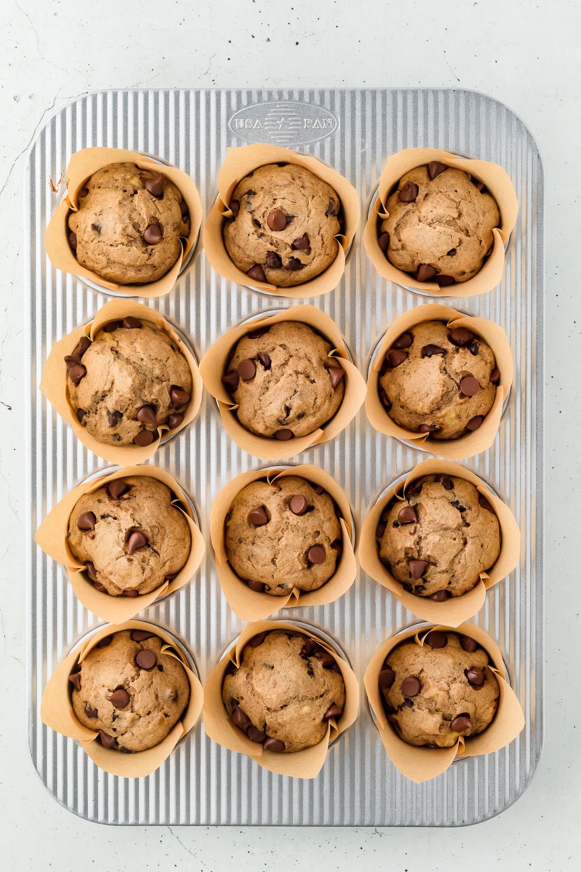 Baked banana chocolate chip muffins in the muffin tin