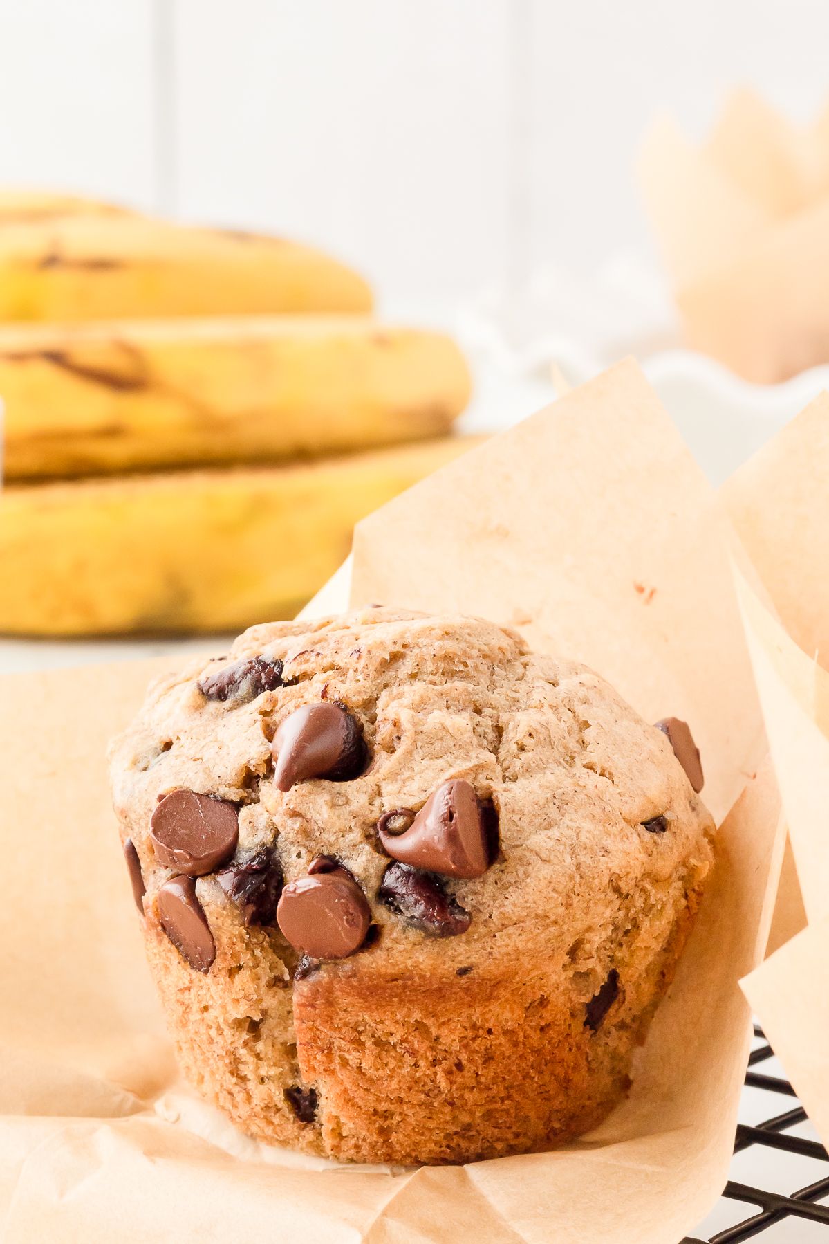 Close up of a banana chocolate chip muffin with melty chocolate chips