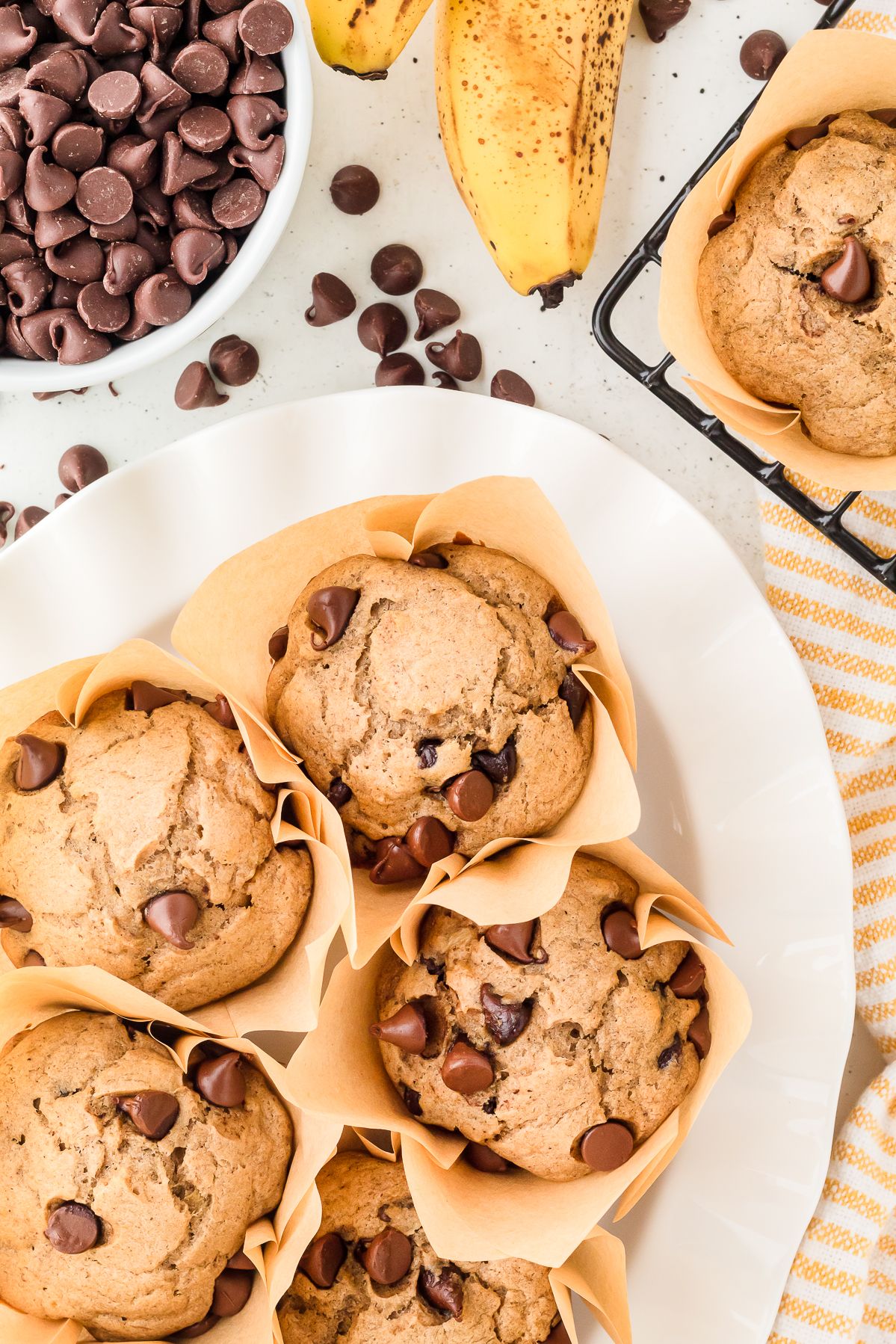Overhead view of banana chocolate chip muffins on a plate