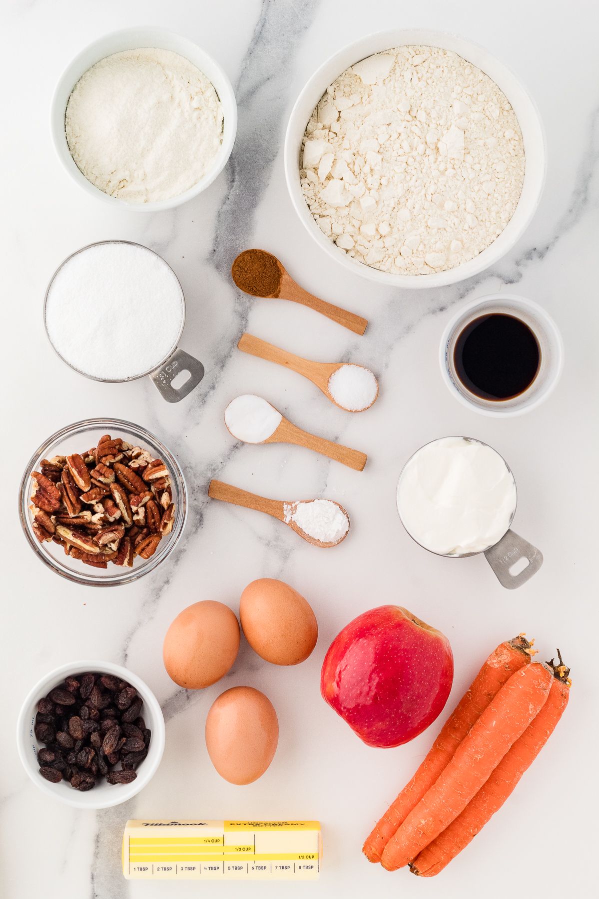 Ingredients for gluten free morning glory muffins: gluten free flour, carrots, apple, raisins, pecans, eggs and spices