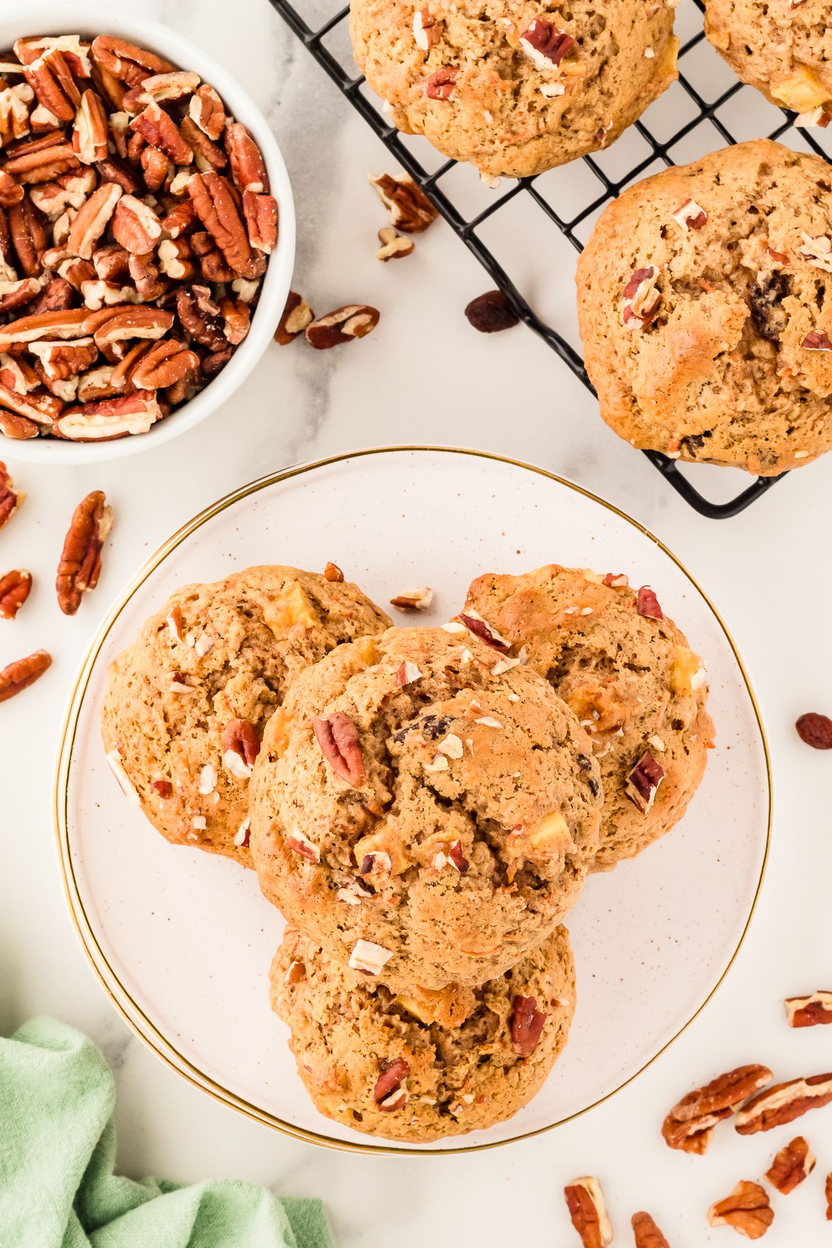 Overhead view of gluten free morning glory muffins on a plate with pecans and raisins