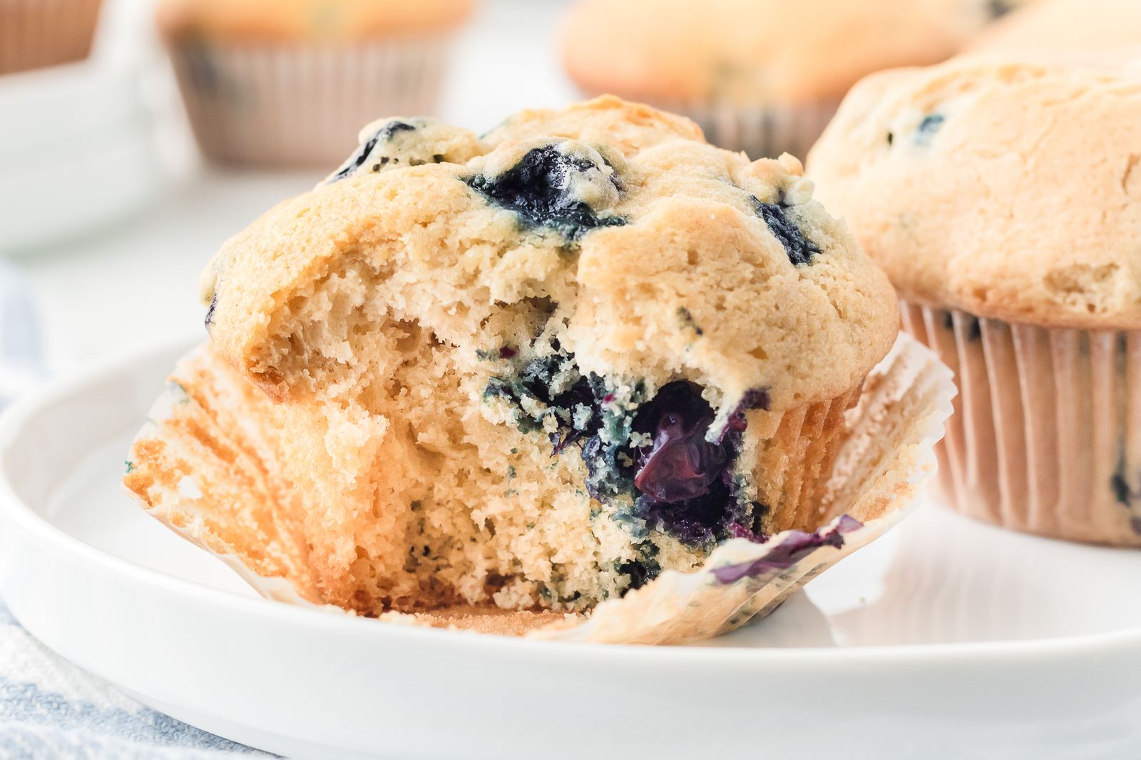 Healthy blueberry muffin with a bite taken out showing juicy berries