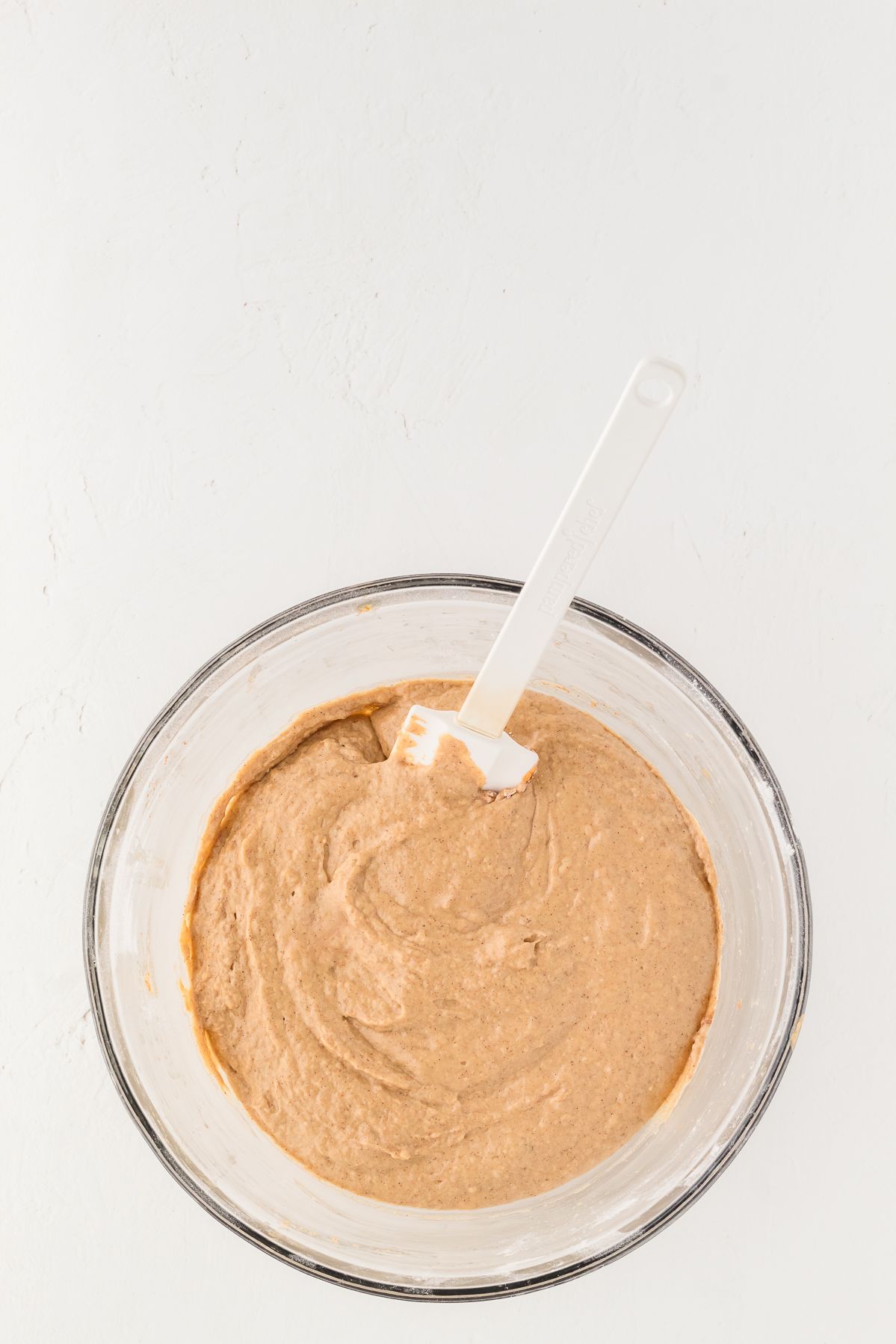 Healthy pumpkin muffin batter in a glass bowl