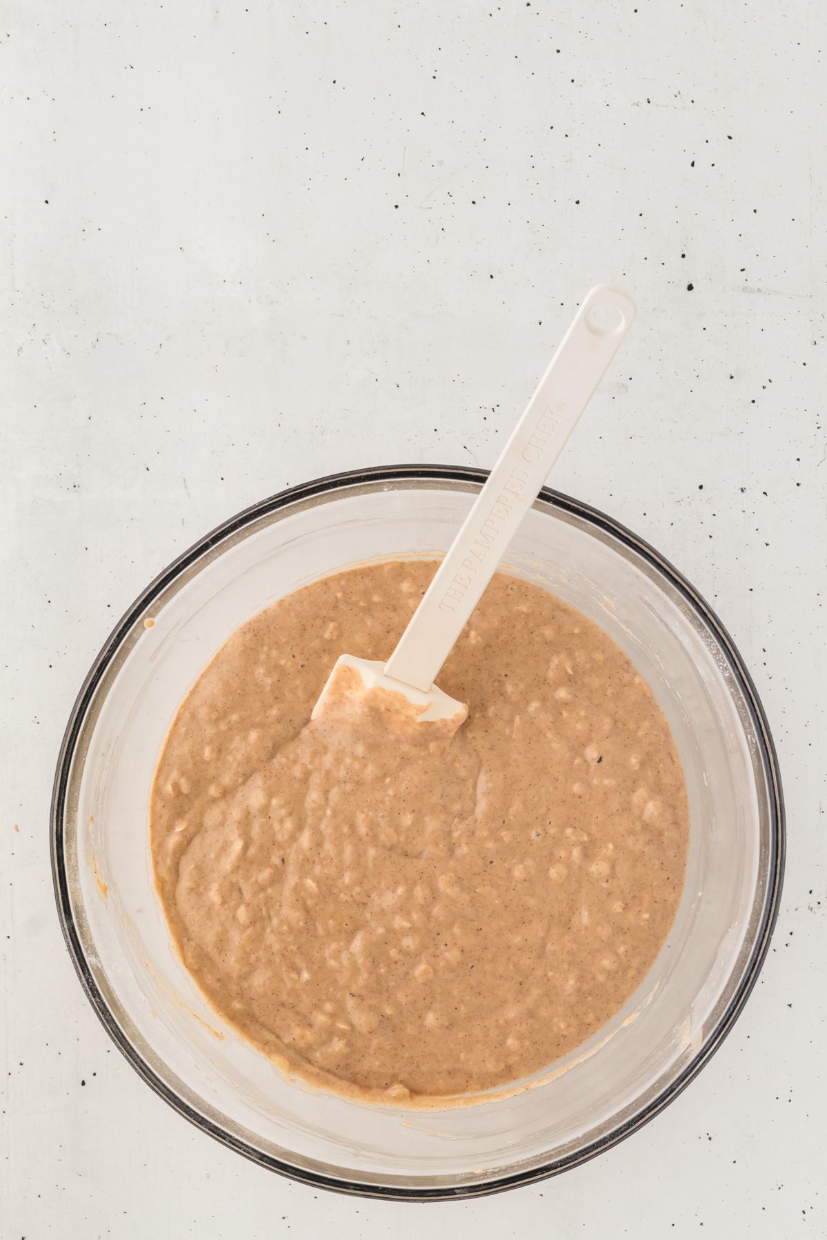 Banana oatmeal muffin batter in a glass bowl