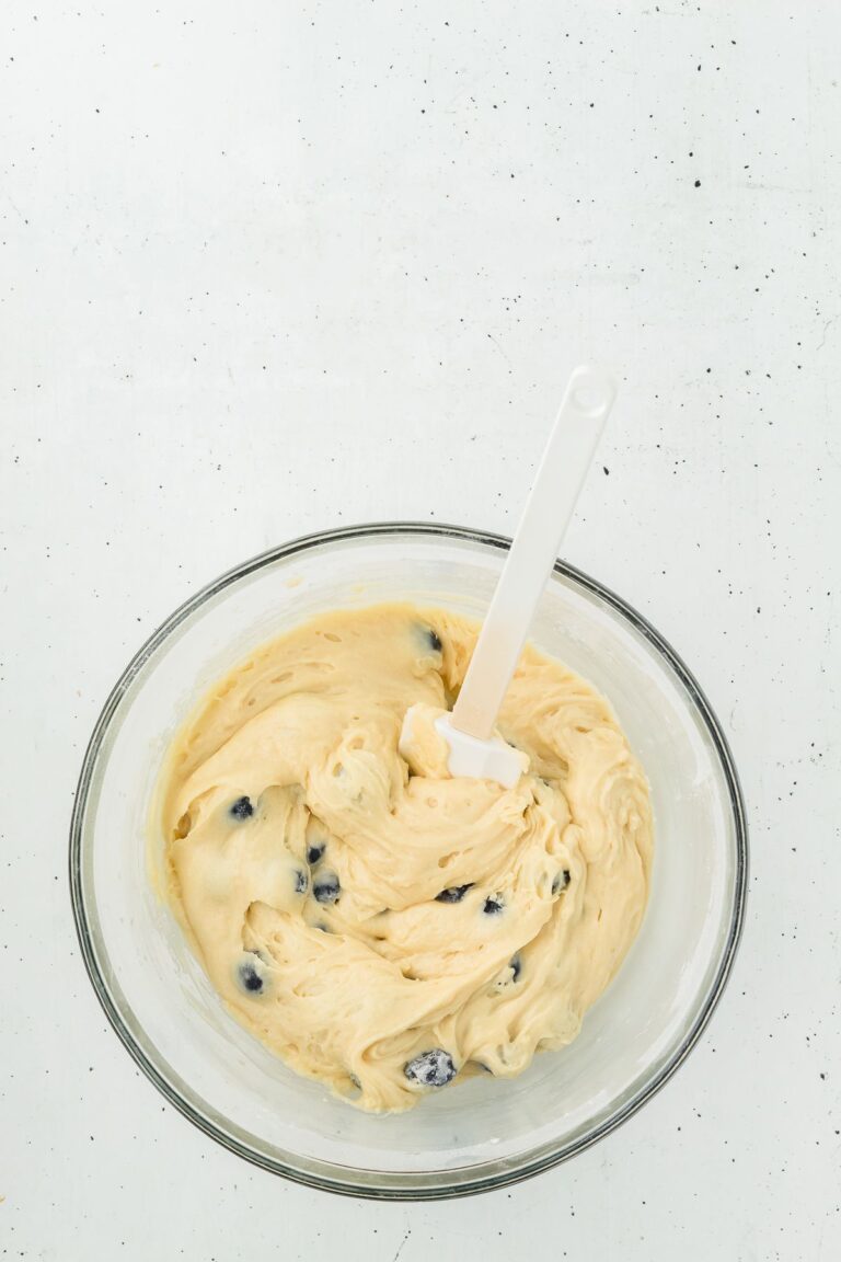 Folding blueberries into lemon blueberry muffin batter